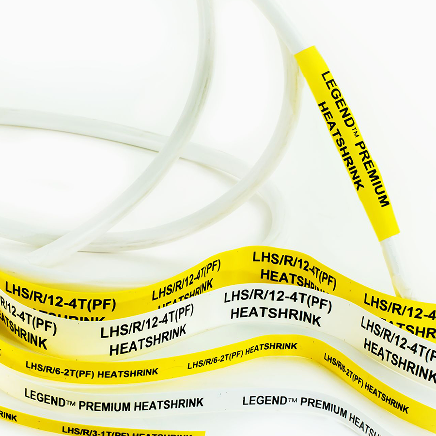 Yellow and white heatshrink tubing labels with black text, including “LEGEND™ PREMIUM HEATSHRINK” and codes like “LHS/R/12-4T(PF)